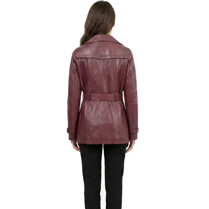 Back view of burgundy leather trench jacket showing center back seam belt detail and mid length hem