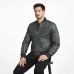 Seated view of gray leather bomber jacket showing smooth leather panels ribbed hem waistband and classic construction