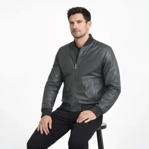 Seated view of gray leather bomber jacket showing smooth leather panels ribbed hem waistband and classic construction