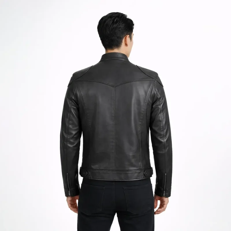 Rear view of black leather cafe racer jacket showing center back seam, shoulder panels, tapered waist construction, and straight hem detail