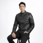 Man seated wearing black leather cafe racer jacket showing comfortable fit, natural leather draping, pocket accessibility, and unrestricted movement while sitting