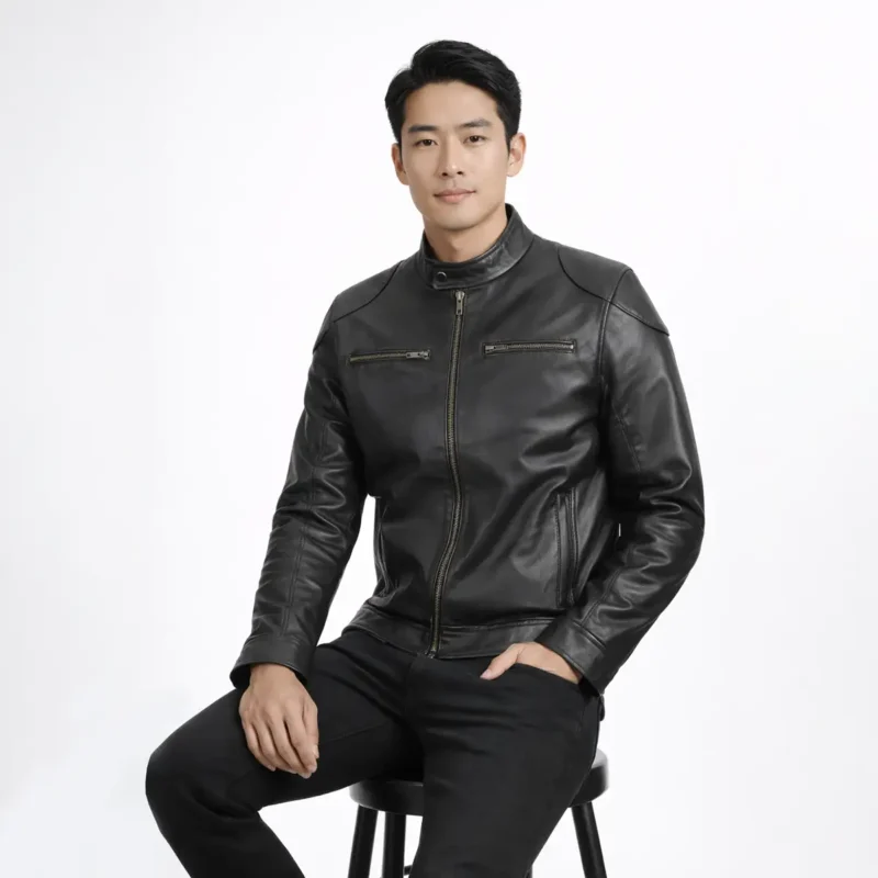 Man seated wearing black leather cafe racer jacket showing comfortable fit, natural leather draping, pocket accessibility, and unrestricted movement while sitting