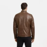 Rear view of cognac brown leather aviator jacket showing center back seam, shoulder construction, straight hem with zipper adjusters, and smooth leather finish
