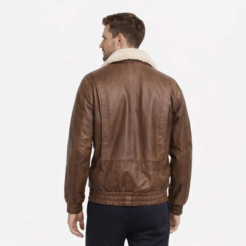 Rear view of brown leather aviator jacket showing clean back panel, elasticated hem and cuffs, shearling collar, classic bomber construction