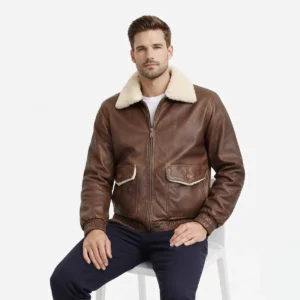 Man seated wearing brown leather aviator jacket showing comfortable fit, luxurious shearling collar, functional chest pockets, practical everyday wear