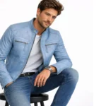 Man wearing light blue leather cafe racer jacket while seated, demonstrating comfortable fit and flexible leather construction
