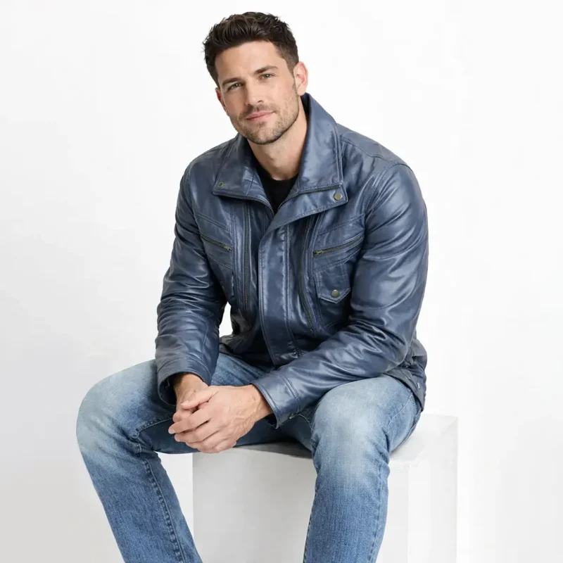 Man wearing navy blue distressed leather bomber jacket while seated, showing comfortable fit and soft leather texture