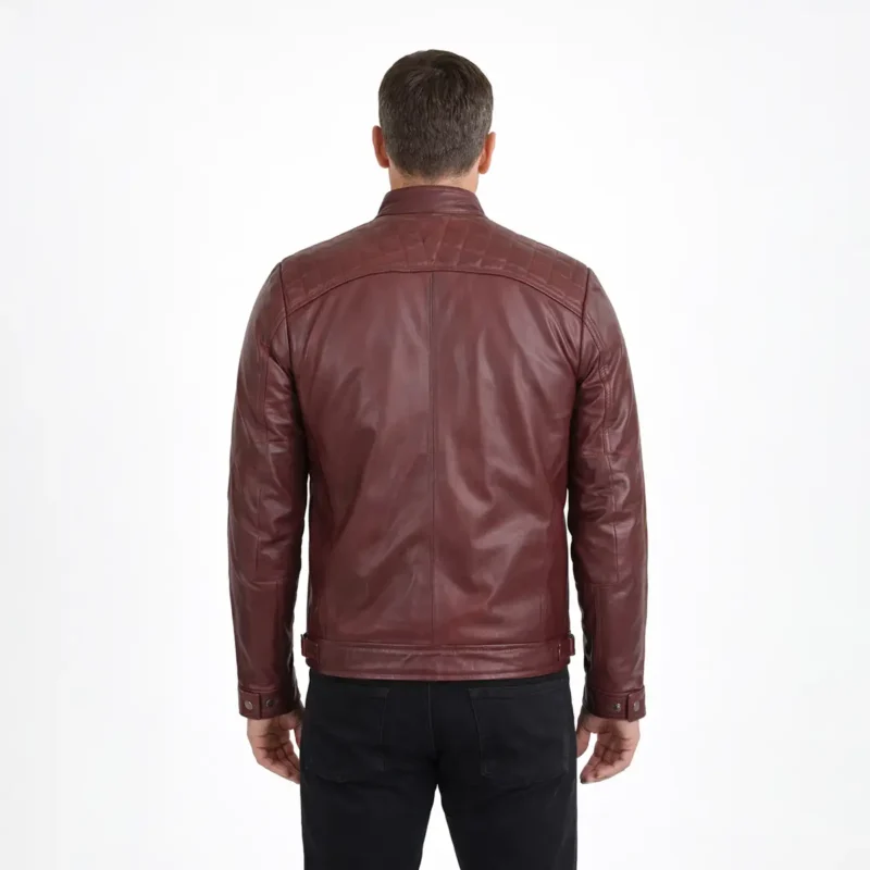 Rear view of burgundy wine-colored leather cafe racer jacket showing raglan sleeve seams, center back panel, straight hem with side adjusters, and rich oxblood finish