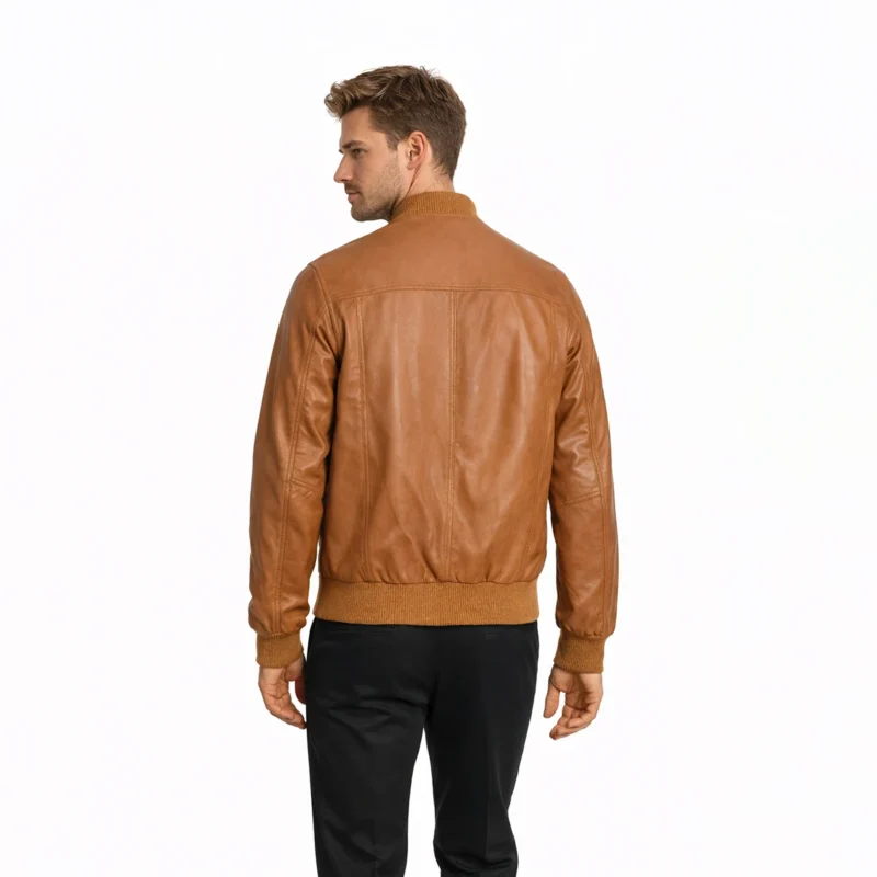 Rear view of tan cognac leather bomber jacket showing clean back panel, ribbed knit hem, smooth leather finish, center back construction, and timeless flight jacket proportions
