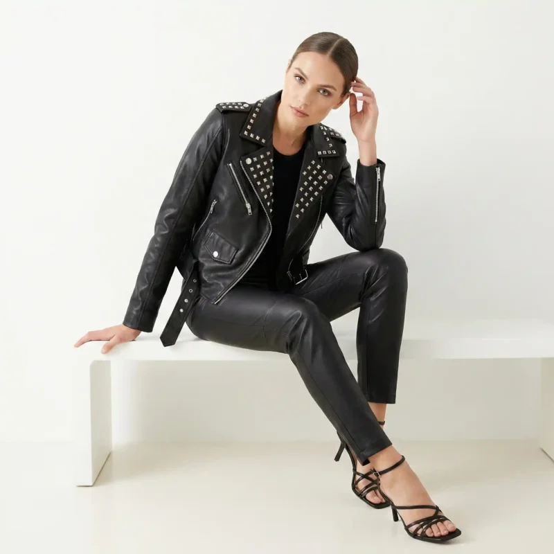 Front view of women’s black studded leather fashion jacket with zip-front design