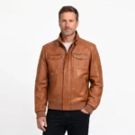 Men's tan brown leather bomber jacket with stand-up buckle collar, dual chest pockets with zippers, ribbed cuffs and waistband - front view