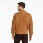 Rear view of tan camel suede bomber jacket showing clean back panel, ribbed knit hem, soft nubuck texture, center back construction, and luxurious suede finish