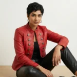 Woman wearing red leather military style commander jacket with decorative buttons front view