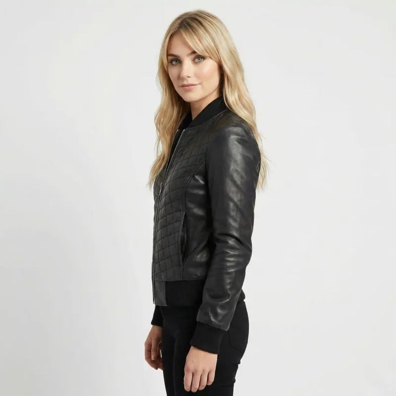 Side profile of Eclipse black leather bomber jacket showing quilted body panel, smooth leather sleeve, ribbed side panels, and cropped length