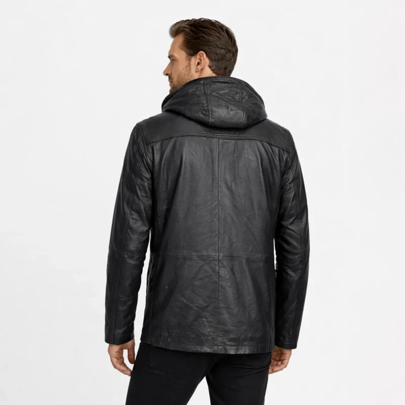 Rear view of black leather field jacket showing removable hood, clean back panel, relaxed fit, hip-length cut