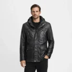 Front view of men's black leather field jacket with removable hood, snap and zip closure, chest zip pockets, flap waist pockets, drawstring hood