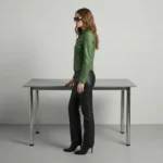 Side profile of emerald green leather jacket showing stand collar, fitted waist, cropped length, and sleek racer silhouette