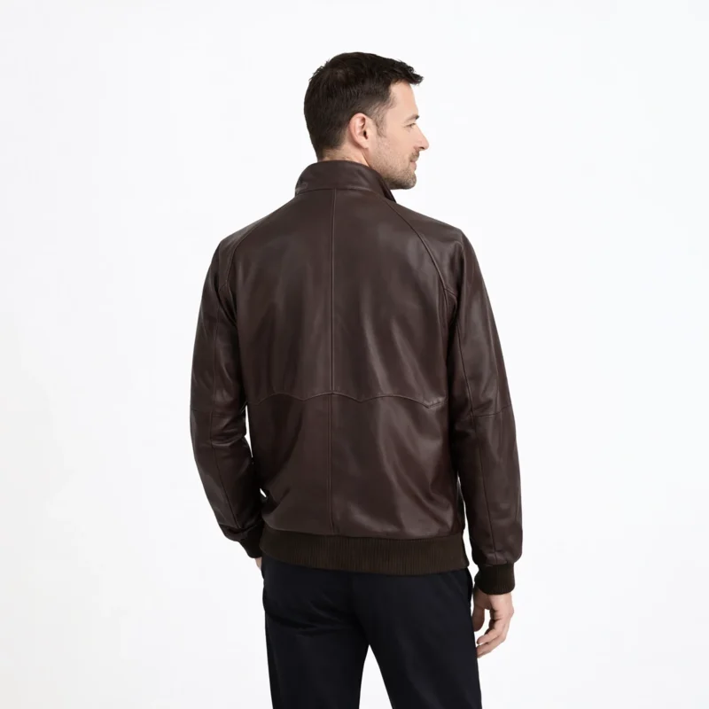 Rear view of brown leather Harrington jacket showing raglan sleeves, clean back panel, ribbed hem, and classic bomber construction