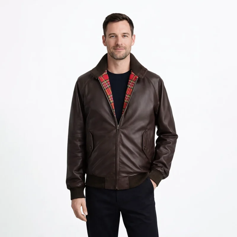 Front view of men's brown leather Harrington jacket with fold-down collar, red tartan plaid lining, central zipper, slash hand pockets, ribbed cuffs and hem