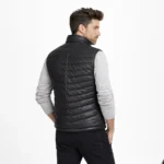 Rear view of black leather puffer vest showing horizontal quilted channels, clean back construction, stand collar, sleeveless design of Ironcrest Obsidian Leather Field Vest