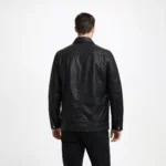 Rear view of black leather bomber jacket showing vertical topstitching panels on back, relaxed fit through shoulders and torso, ribbed knit hem, and classic aviator construction