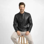 Man seated wearing black leather racer jacket showing comfortable fitted cut, streamlined design, versatile styling - Midnight Sleek Jacket