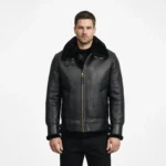 Man wearing black leather shearling jacket with fur collar and gold zipper front on white background - Midnight Sovereign Shearling Jacket