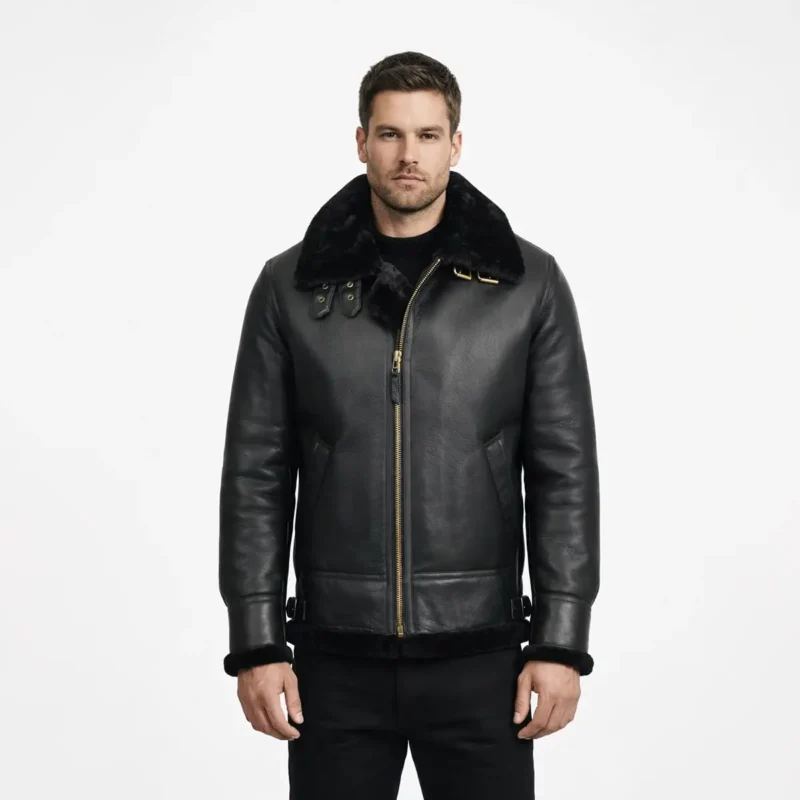 Man wearing black leather shearling jacket with fur collar and gold zipper front on white background - Midnight Sovereign Shearling Jacket