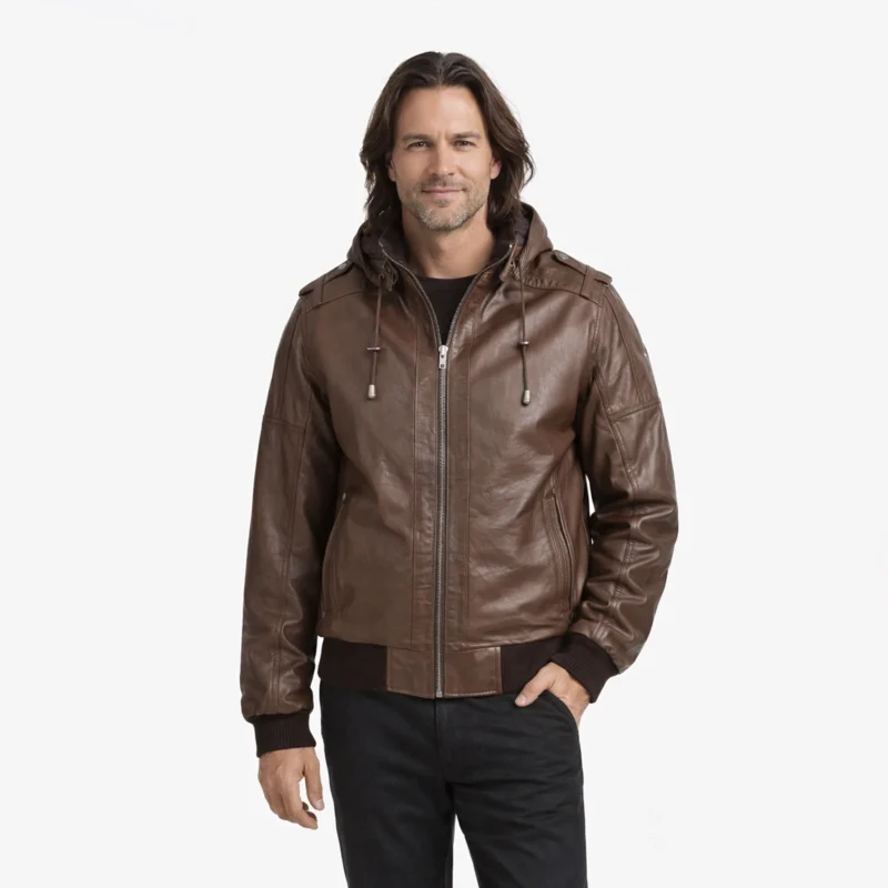 Men's brown leather bomber jacket with removable hood, shoulder epaulettes, front zipper closure, and ribbed cuffs and waistband - front view