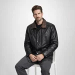 Man seated wearing black leather car coat with brown collar showing comfortable fit, accessible pockets, practical everyday wear - Noir Sentinel Luxury Leather Coat