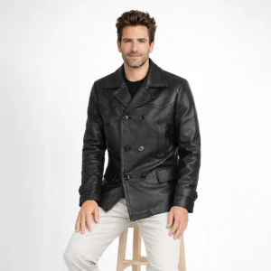 Man wearing black leather peacoat while seated, demonstrating comfortable fit, double-breasted styling, and wide lapel detail of Noir Sovereign Leather Blazer