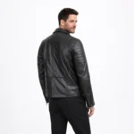 Rear view of black leather motorcycle jacket showing quilted shoulder panels, ribbed side panels, and slim fitted back design