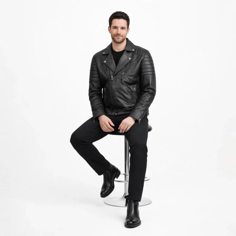Man seated wearing black leather motorcycle jacket showing comfort, flexibility, and maintained structure while sitting
