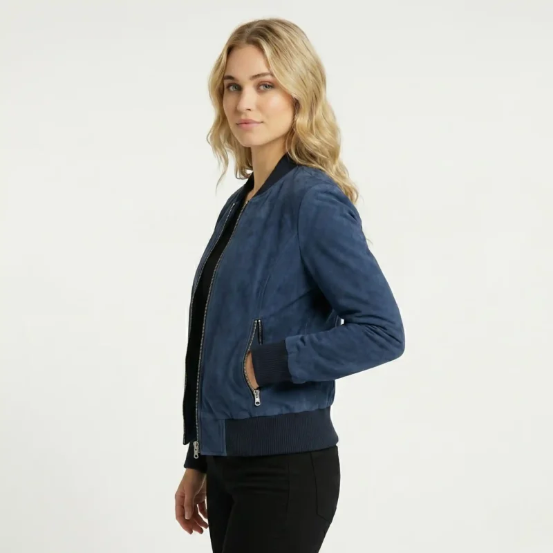 Side profile of navy suede bomber jacket showing ribbed collar and cuffs, zippered pocket, fitted feminine silhouette, luxurious nubuck finish of Noir Vantique Leather Bomber Jacket