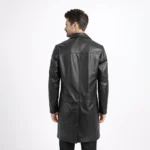 Back view of black leather car coat showing center back seam vertical stitching and mid thigh length hem - Obsidian Regent Leather Coat