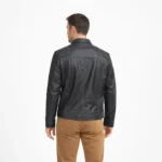 Rear view of black leather racer jacket displaying diamond quilted shoulder yoke, smooth back panel, and fitted waist hem