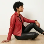 Side profile of red leather moto jacket showing asymmetric zipper, wide lapels, fitted feminine silhouette, chest and waist pockets - Opulence Core Leather Jacket