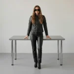 Women's black leather moto jacket with band collar, front zipper closure, diagonal zipper pockets, and fitted silhouette - front view of Raven Glide Moto Jacket