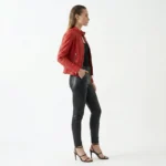 Side profile of Royal Vibe red leather asymmetrical jacket showing fitted silhouette, stand collar, asymmetric zipper, and structured shoulders