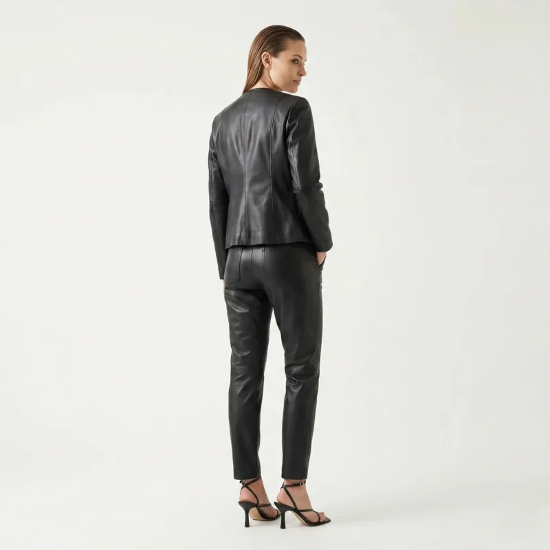 Rear view of Shadow Muse black leather jacket showing smooth back panel, princess seams, fitted waist, and hip-length cut - Shadow Muse Jacket
