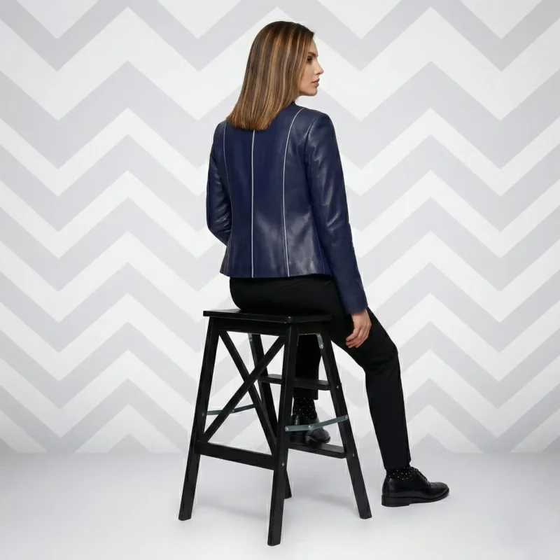 Side profile of navy blue leather blazer showing fitted silhouette, stand collar, hip-length cut, and sleek tailored construction - Signature Sculpted Navy Leather Jacket