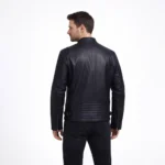 Rear view of black leather motorcycle jacket showing ribbed shoulder panels, smooth back construction, and fitted silhouette