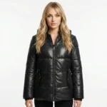 Woman wearing black quilted leather puffer jacket with front zipper closure and side pockets, front facing view of Velora Arctic Elite Black Leather Puffer