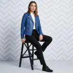 Woman wearing royal blue leather moto jacket with asymmetric zipper and wide lapels sitting on black stool - Velour Rebel Leather Jacket