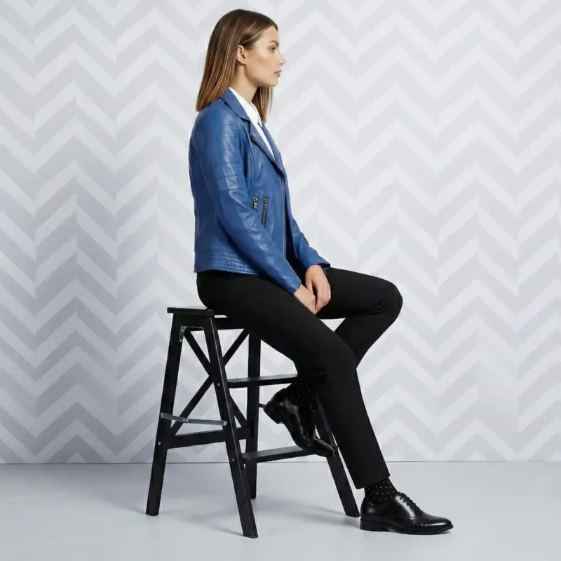 Side profile of woman in royal blue leather moto jacket showing fitted silhouette hip length and asymmetric zipper - Velour Rebel Leather Jacket