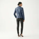 Back view of slate blue leather moto jacket showing center back seam tailored shoulders and hip length hem