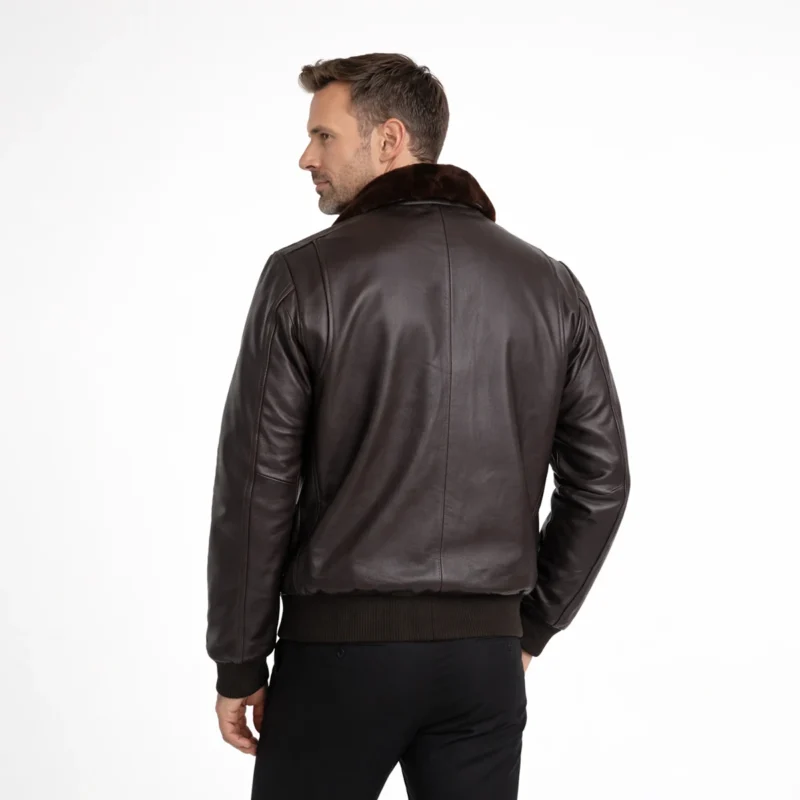 Rear view of black leather aviator jacket showing fur collar, shoulder epaulets, clean back panel, ribbed hem, classic bomber construction