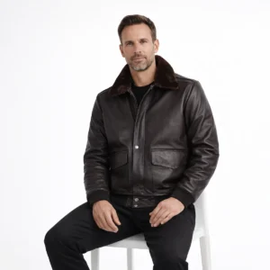 Man seated wearing black leather aviator jacket showing comfortable fit, luxurious fur collar, functional chest pockets, practical cold weather wear