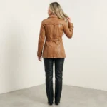 Back view of women’s caramel leather trench jacket with waist belt and tailored silhouette