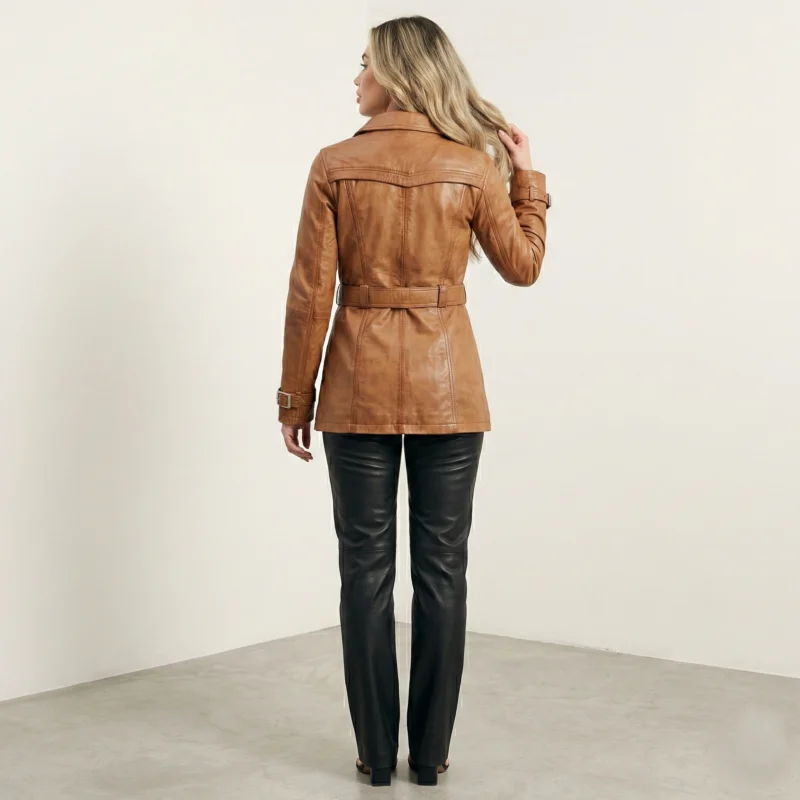 Back view of women’s caramel leather trench jacket with waist belt and tailored silhouette